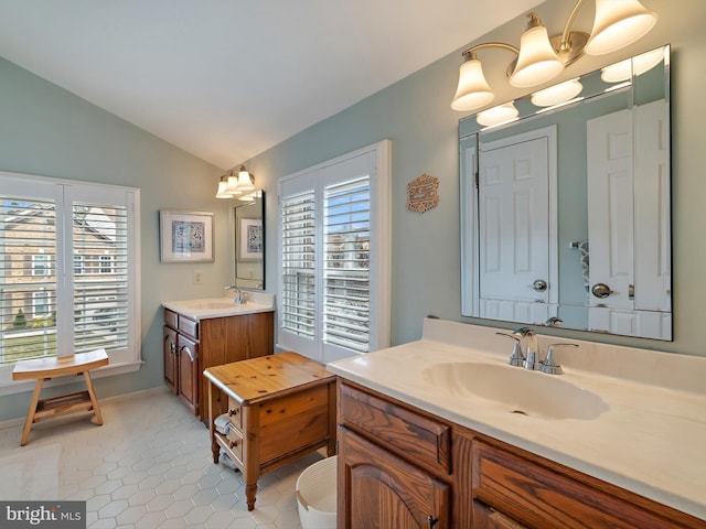 bathroom featuring tile patterned flooring, a notable chandelier, a wealth of natural light, and vaulted ceiling