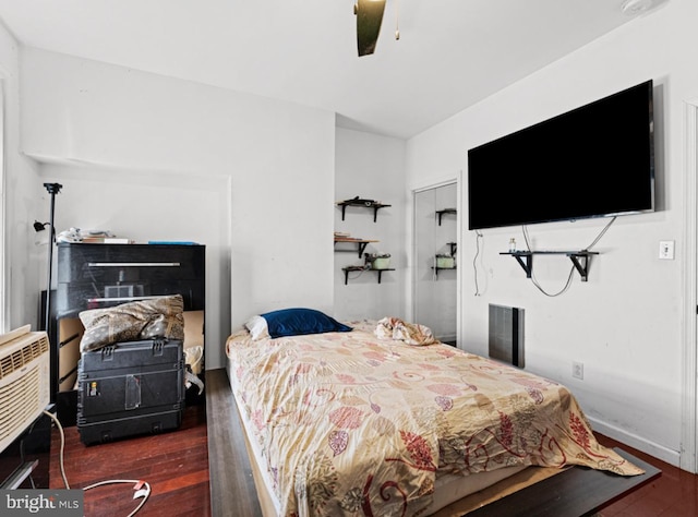 bedroom with ceiling fan and dark wood-type flooring