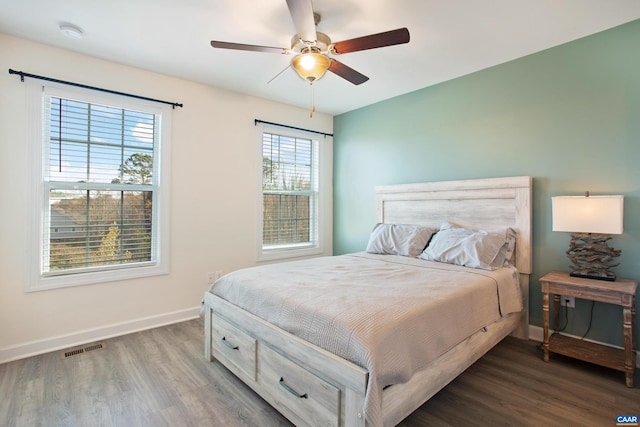 bedroom with ceiling fan and dark hardwood / wood-style flooring