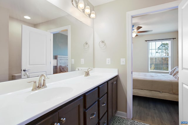 bathroom featuring ceiling fan, hardwood / wood-style floors, vanity, and toilet