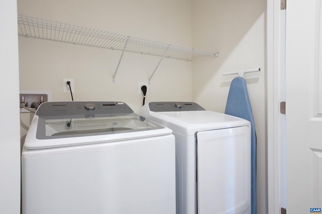 clothes washing area with washing machine and clothes dryer