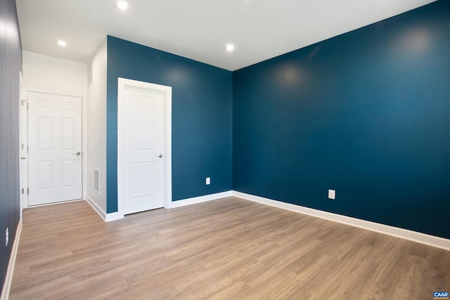 unfurnished room with light hardwood / wood-style floors