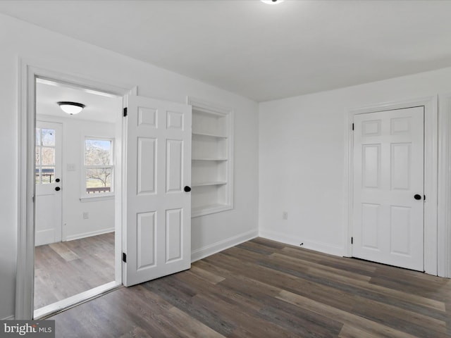 unfurnished bedroom with dark hardwood / wood-style flooring