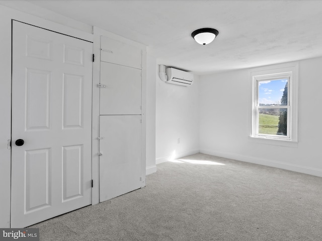 spare room featuring light carpet and a wall unit AC