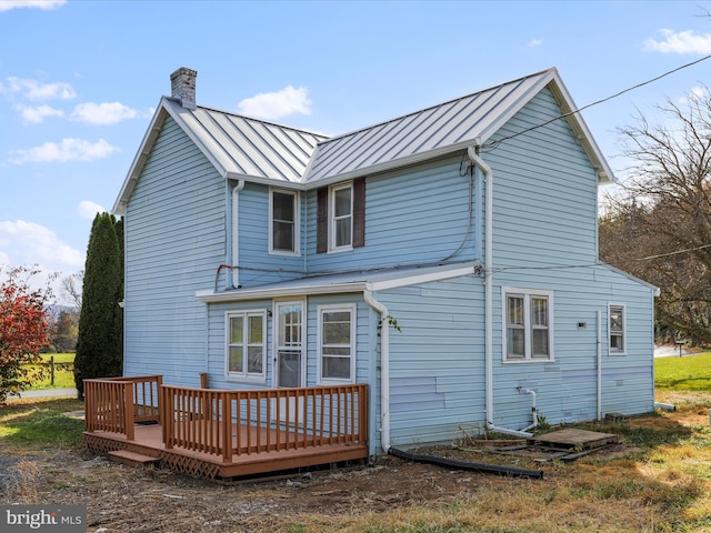 back of house featuring a deck