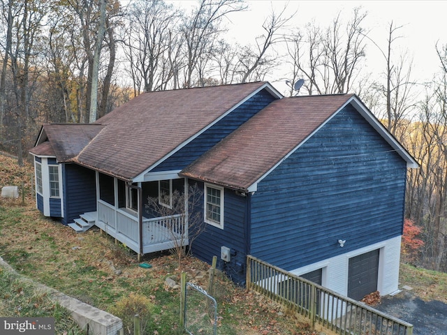 view of home's exterior featuring a porch and a garage