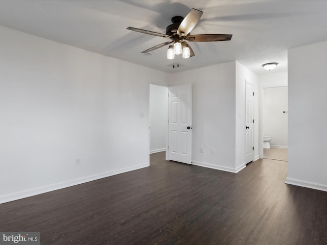 unfurnished room with ceiling fan and dark hardwood / wood-style floors