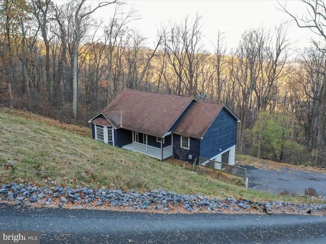 689 Windy Way, Front Royal, VA 22630 - view of front facade featuring a porch, an attached garage, asphalt driveway, and a wooded view