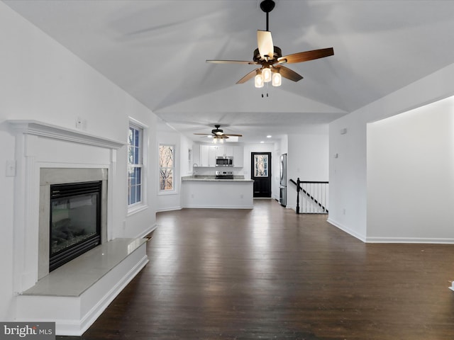 unfurnished living room featuring dark hardwood / wood-style floors and ceiling fan