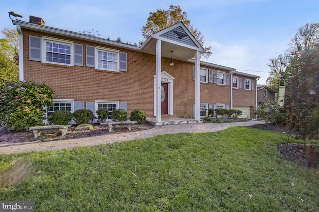 raised ranch featuring a front yard