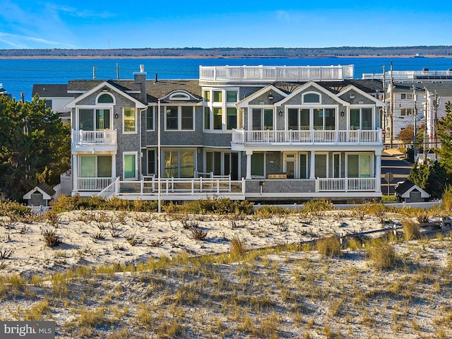 rear view of property featuring a water view