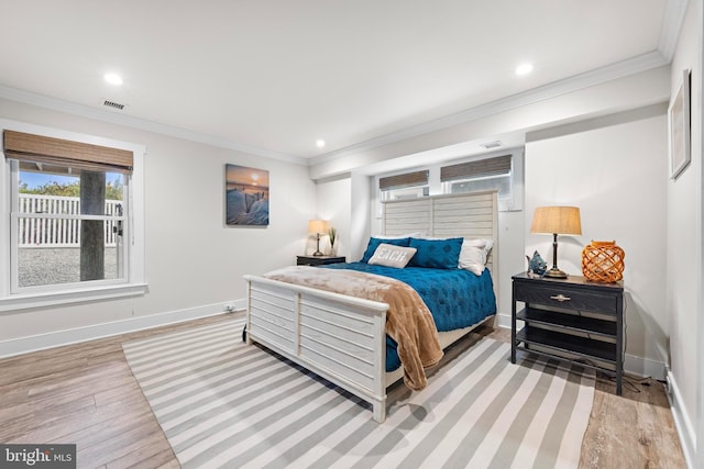 bedroom featuring light hardwood / wood-style flooring and ornamental molding