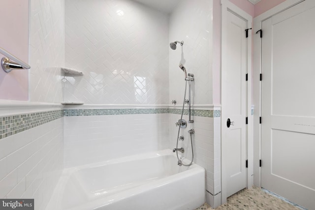 bathroom featuring tile walls and tiled shower / bath