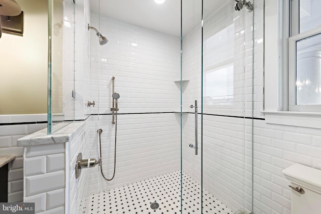 bathroom with a shower with shower door and tile walls