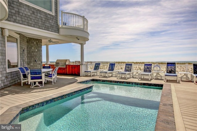 view of swimming pool featuring area for grilling and a patio area