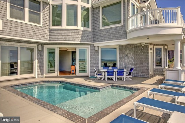 view of swimming pool featuring ceiling fan and a patio