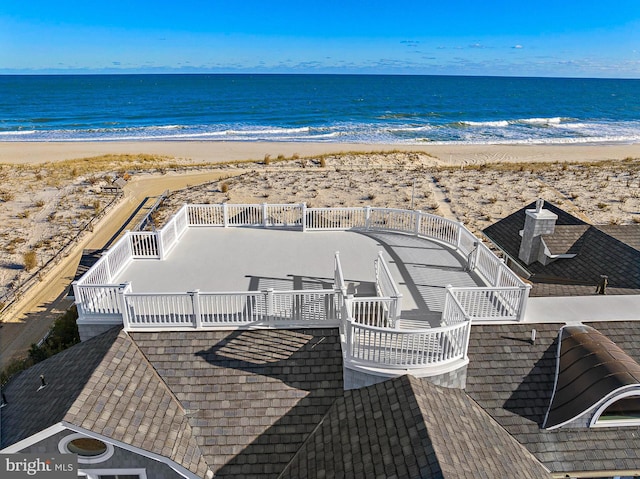 bird's eye view featuring a water view and a beach view