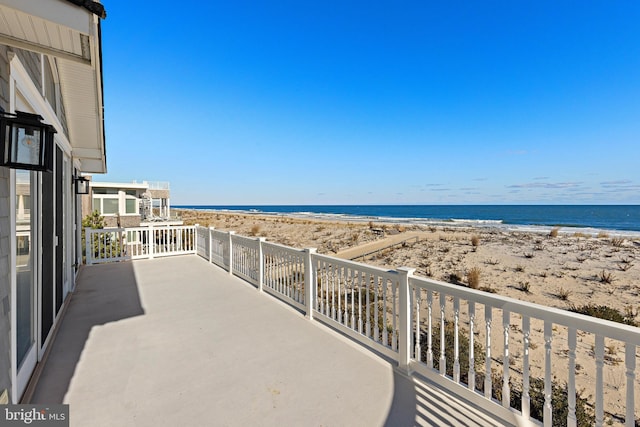 balcony with a view of the beach and a water view