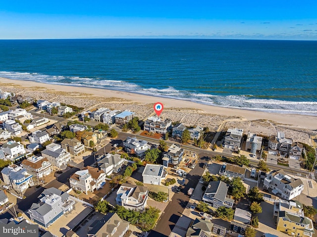 aerial view featuring a water view and a beach view