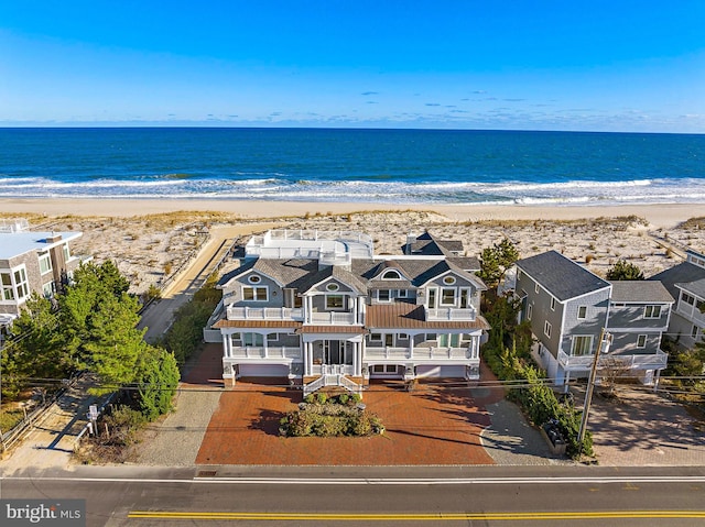 aerial view featuring a water view and a view of the beach