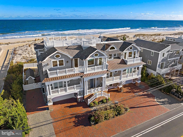 bird's eye view with a water view and a beach view