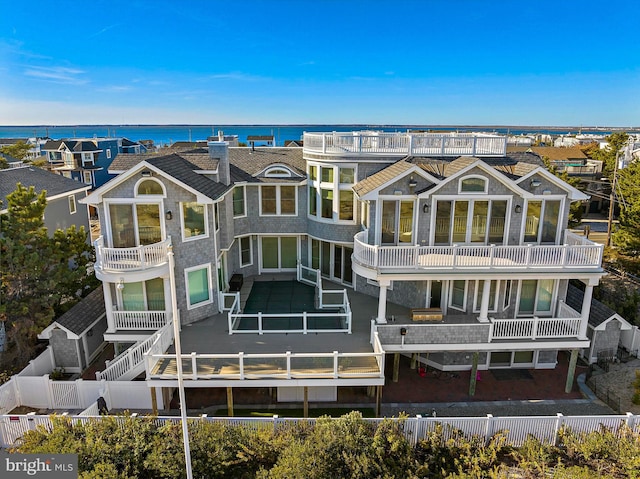 rear view of house featuring a water view