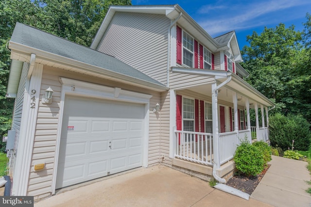 view of front of home with a garage and a porch