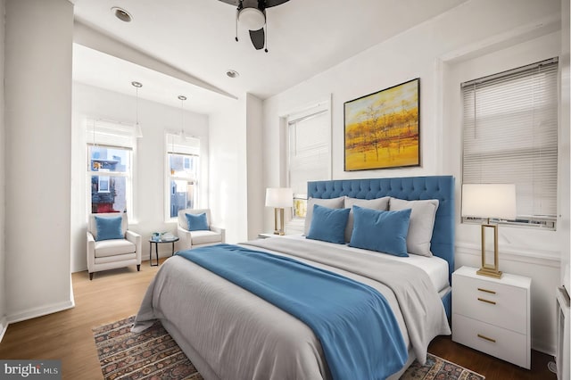 bedroom with ceiling fan and dark wood-type flooring