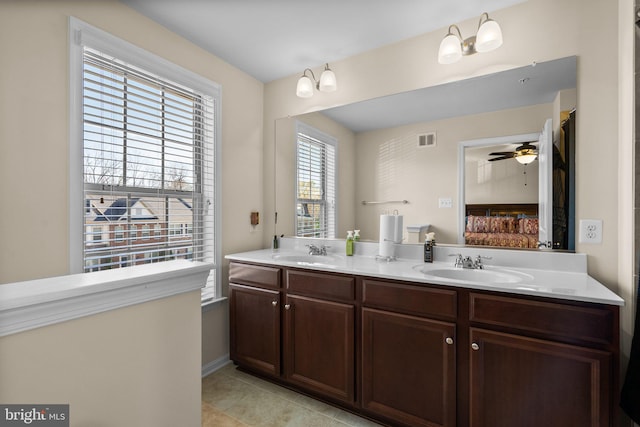 bathroom featuring tile patterned floors, ceiling fan, vanity, and a healthy amount of sunlight