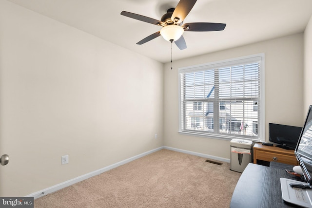 home office with ceiling fan and light carpet