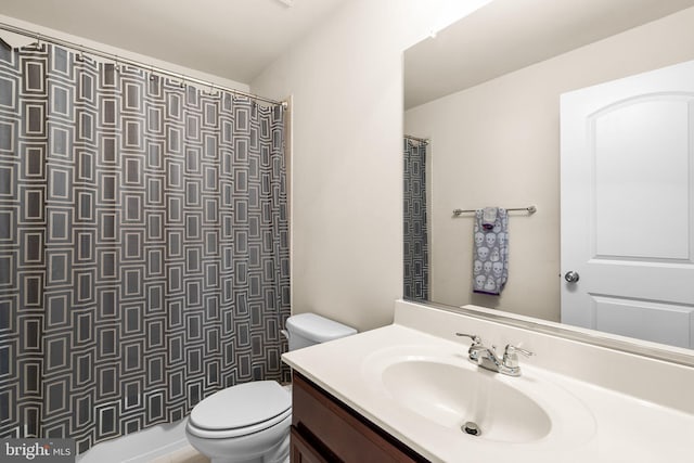 bathroom featuring vanity, curtained shower, and toilet