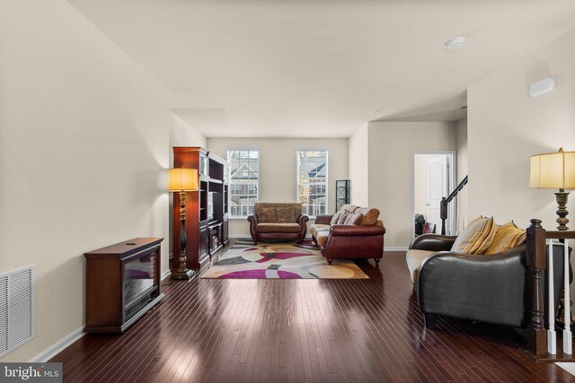 living room with dark hardwood / wood-style flooring