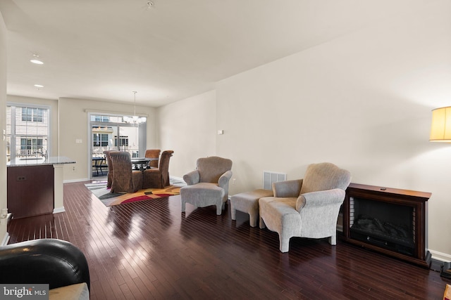 sitting room featuring dark hardwood / wood-style floors and a notable chandelier