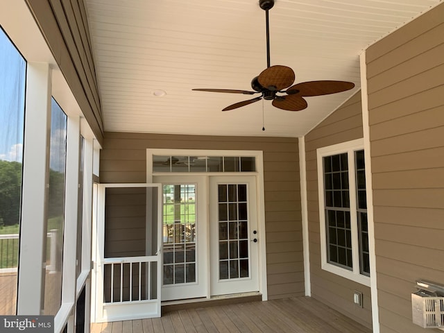 unfurnished sunroom with vaulted ceiling and ceiling fan