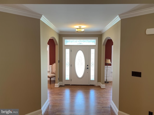 foyer with light hardwood / wood-style floors and ornamental molding