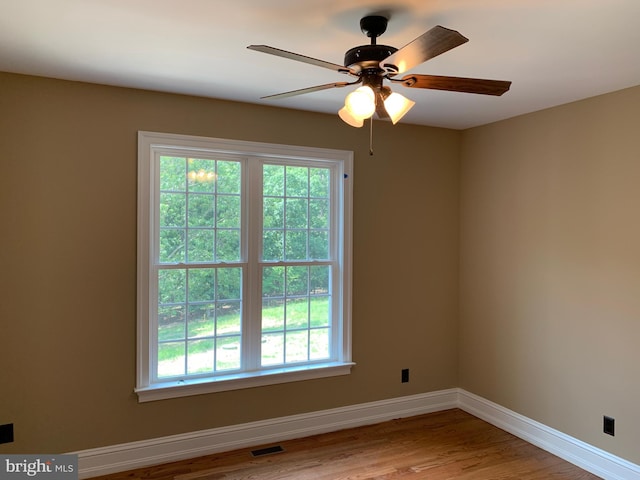 unfurnished room featuring hardwood / wood-style floors, plenty of natural light, and ceiling fan