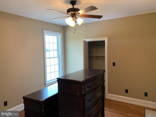 bedroom with ceiling fan, a closet, and hardwood / wood-style flooring