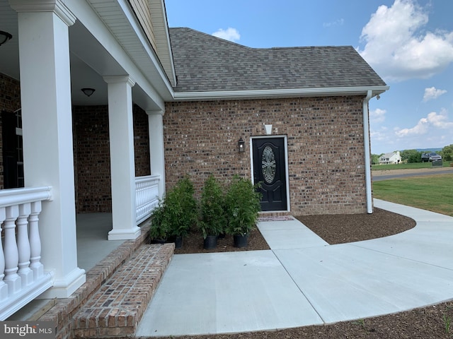 view of exterior entry featuring a porch