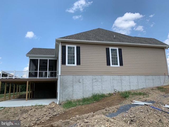 view of property exterior featuring a sunroom