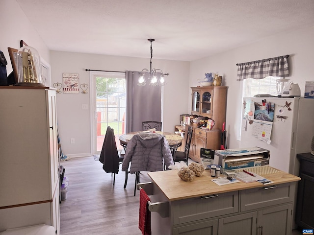 dining space with a chandelier and light hardwood / wood-style flooring