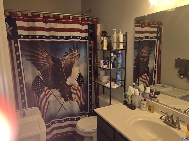 bathroom with vanity, toilet, and curtained shower