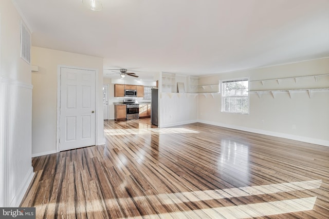 unfurnished living room featuring light wood-type flooring and ceiling fan