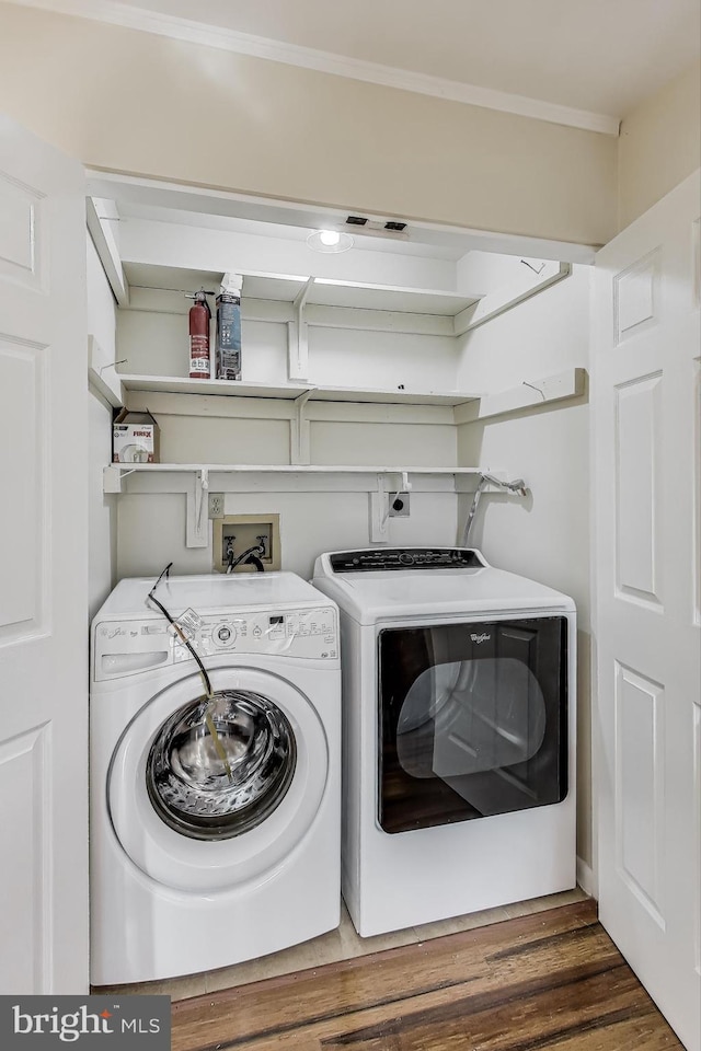 laundry area with dark wood-type flooring and independent washer and dryer