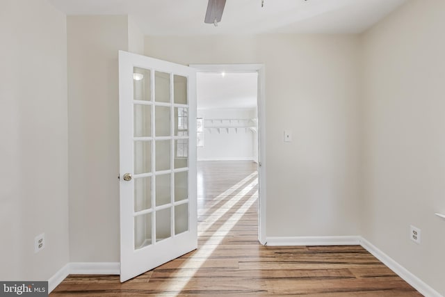 empty room featuring french doors, light hardwood / wood-style flooring, and ceiling fan