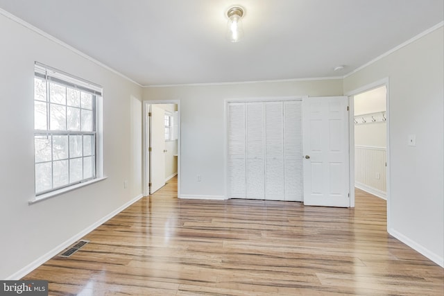 unfurnished bedroom with ornamental molding and light hardwood / wood-style flooring