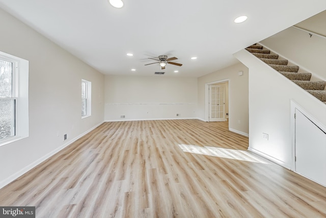 unfurnished living room with ceiling fan and light hardwood / wood-style floors