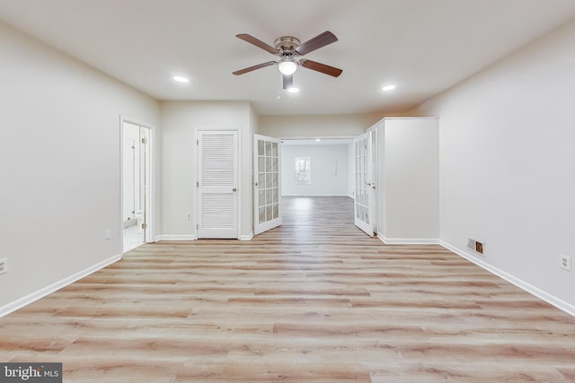 empty room featuring french doors, light hardwood / wood-style flooring, and ceiling fan