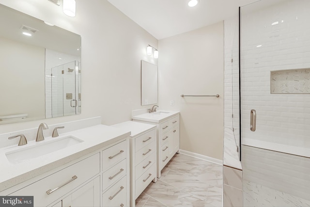 bathroom featuring vanity and a shower with shower door