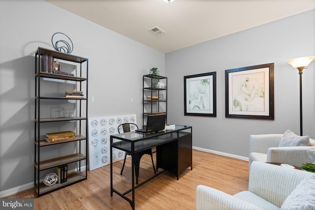 office space with light hardwood / wood-style floors