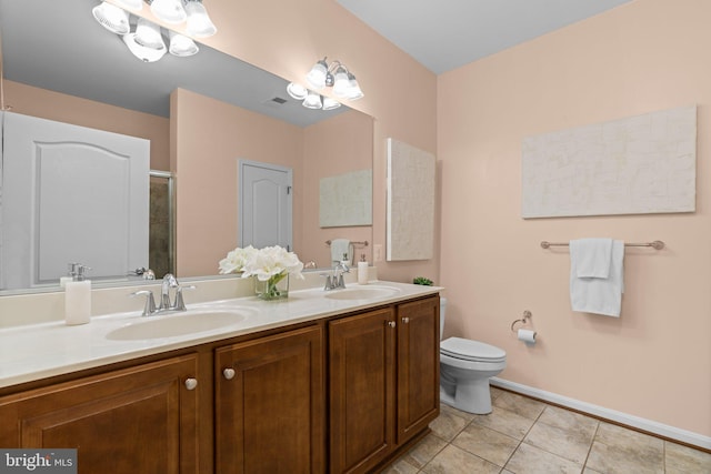 bathroom featuring tile patterned flooring, vanity, an enclosed shower, and toilet